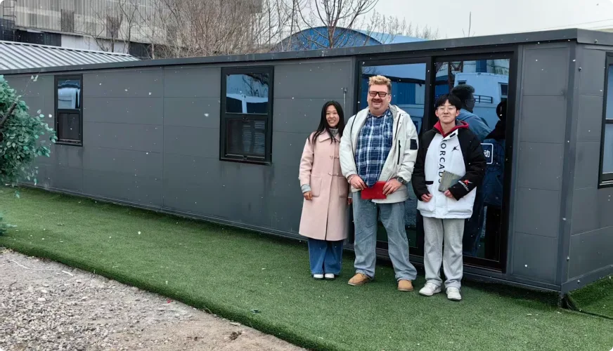 Customer visit outside black modular house